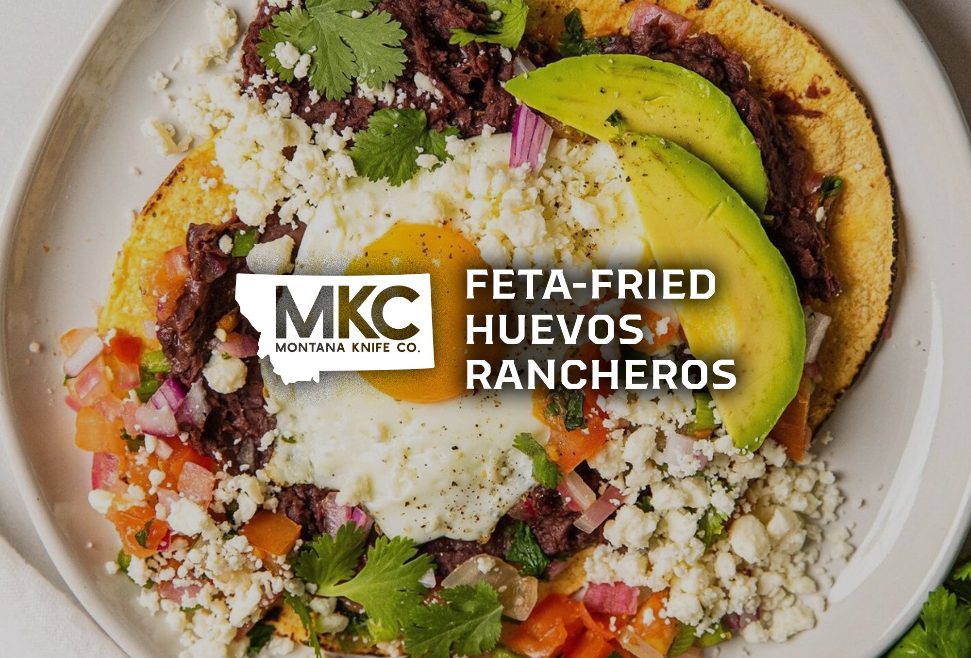 A colorful serving of feta-fried huevos rancheros stands out against a white plate.