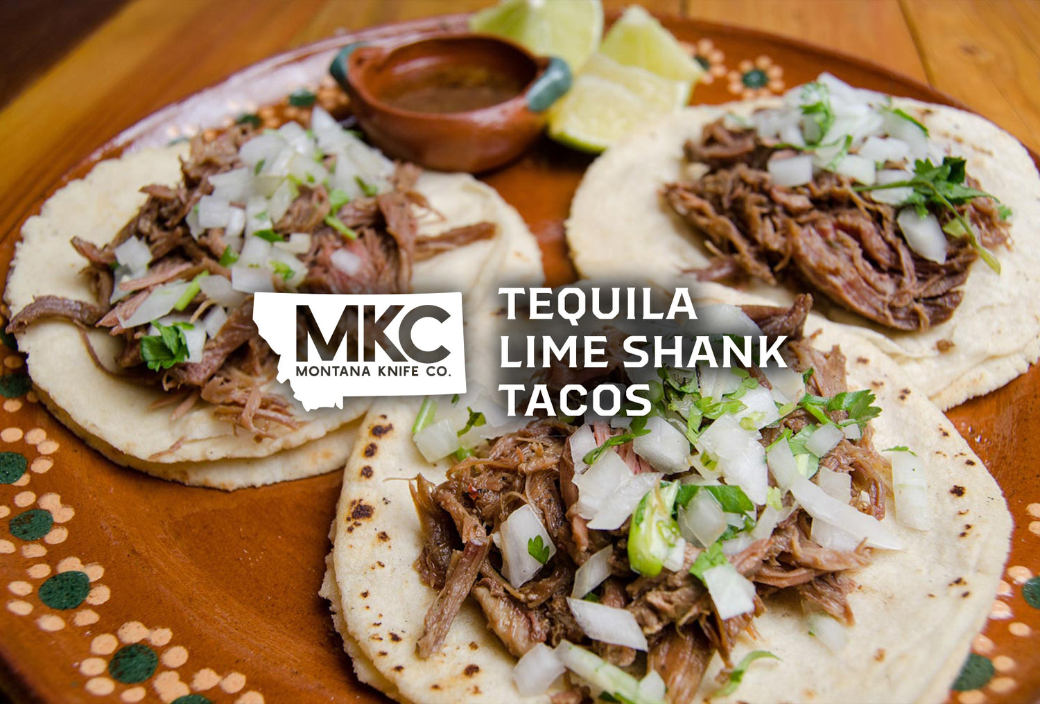 A plate of delicious Mexican lamb tacos, garnished with onions, cilantro, and lime wedges.