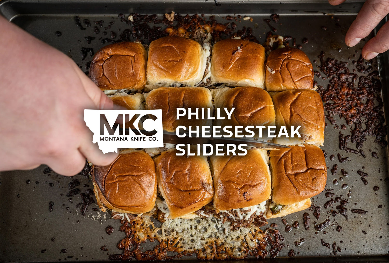 A top-down view of a dozen delicious Philly cheesesteak sliders.