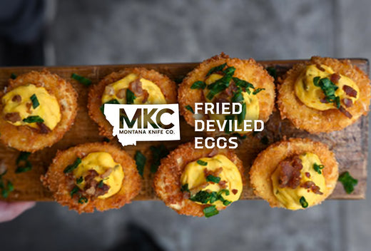 Crispy fried deviled eggs topped with bacon and herbs.