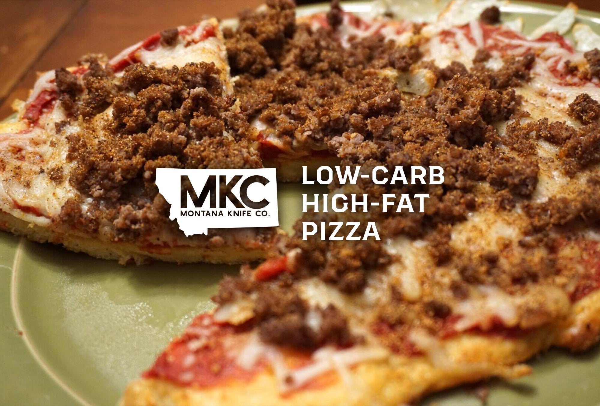 Low-carb, high-fat pizza with seasoned ground meat, cheese, and tomato sauce on a plate.