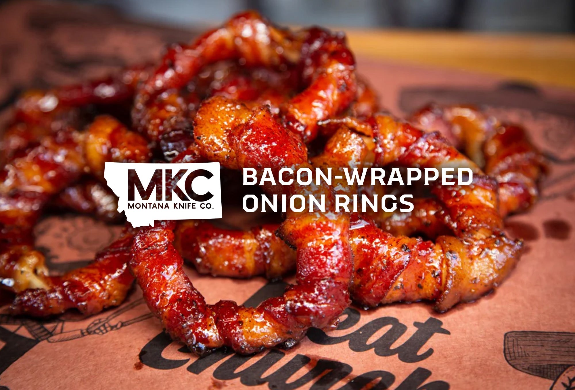 Crispy onion rings wrapped in savory bacon, stacked neatly on a surface, showcasing their irresistible texture and flavor.