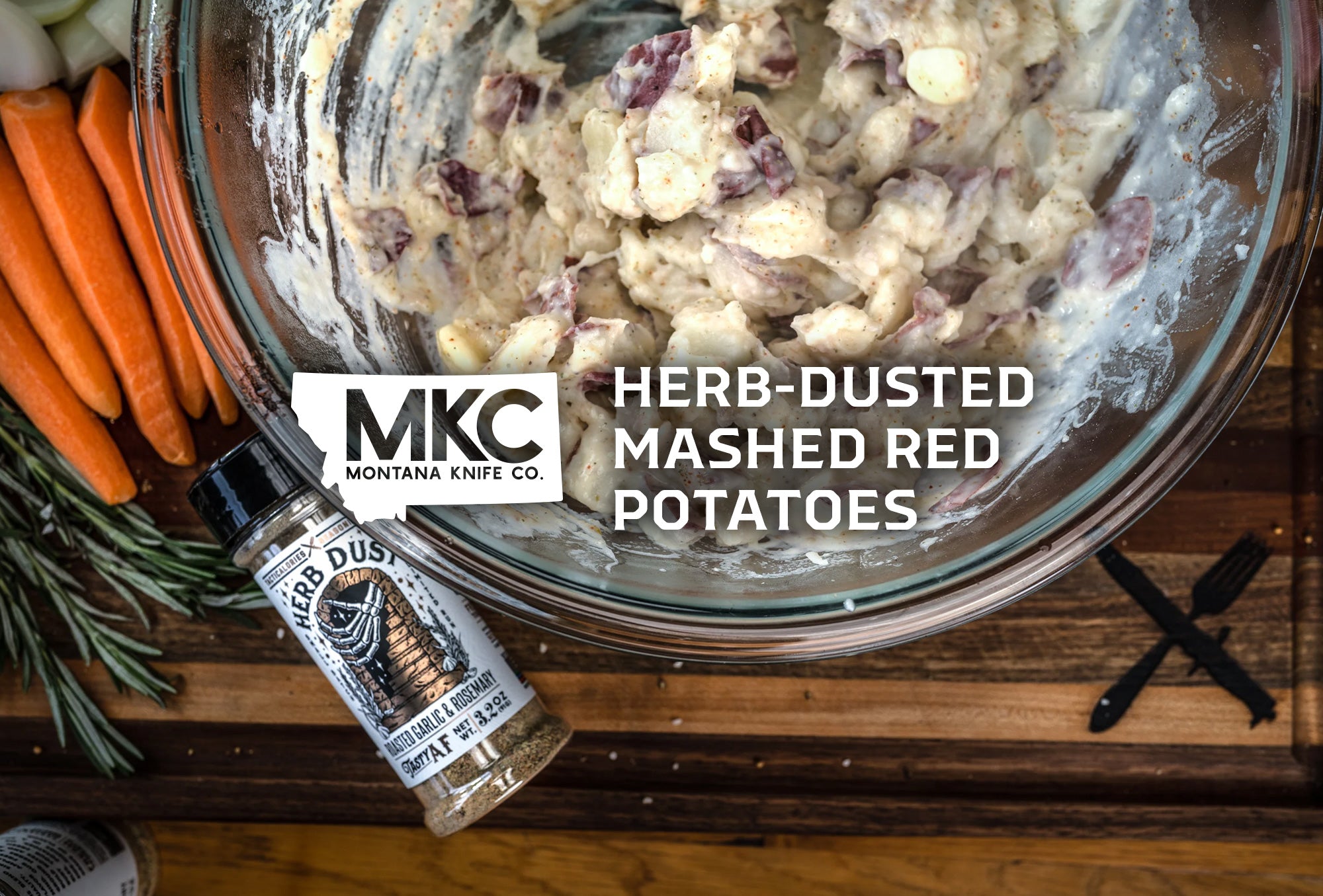 Delicious, creamy, herb-dusted mashed red potatoes in a bowl alongside carrots and herb seasoning.